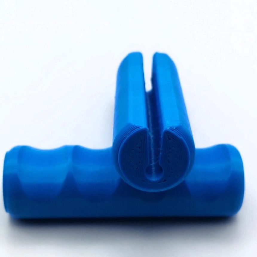 A blue plastic object sitting on top of a table.