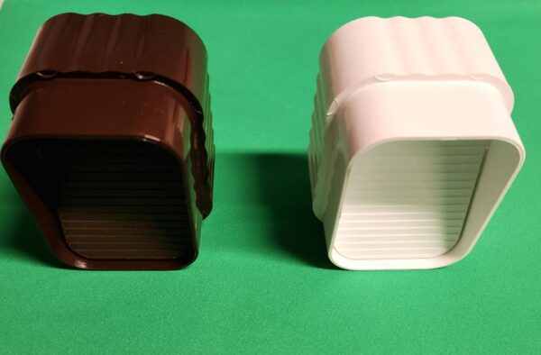 Two chocolate and white cups on a table.