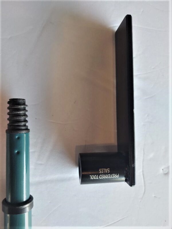 A green object next to a black object on the wall.