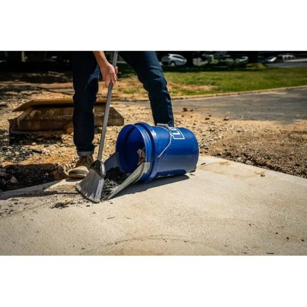 A person digging with a shovel and bucket.