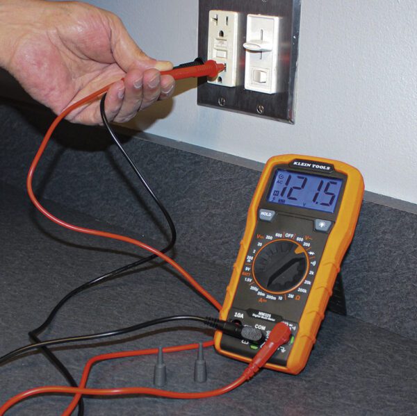 A person is testing the voltage of an electrical device.