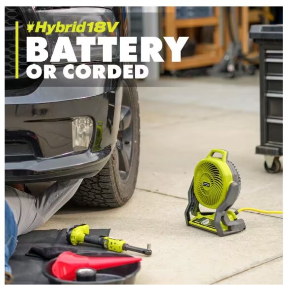 A car is parked in the driveway with tools.