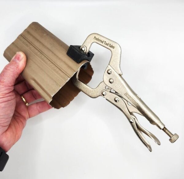 A person holding a key chain with a wooden case.