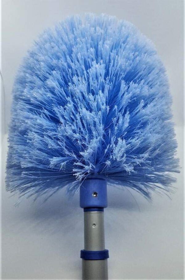 A blue duster is on the handle of a brush.